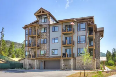 a large apartment building with a garage at Clearwater Lofts - New! Modern 2 Bedroom Near Keystone Lake in Keystone