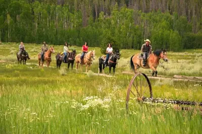 a group of people riding horses in a field at Clearwater Lofts - New! Modern 2 Bedroom Near Keystone Lake in Keystone