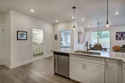 a kitchen with a counter top and a living room at Clearwater Lofts - New! Modern 2 Bedroom Near Keystone Lake in Keystone