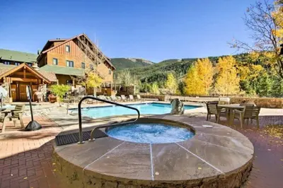 a hot tub in the middle of a patio at River Run Village Condos - 2 Bedroom - Walk To Lift! in Keystone