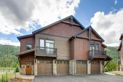 a large house with a garage at River Run Townhomes - 3 Bedroom - Walk To Slopes! in Keystone