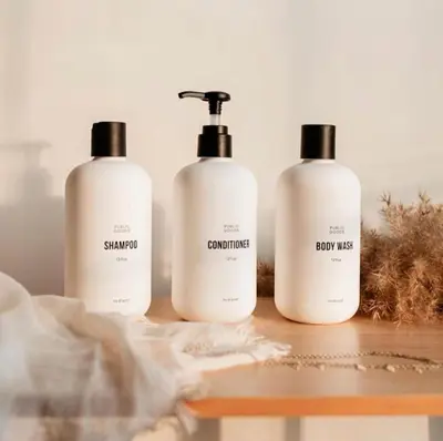 three bottles of shampoo and conditioner sitting on a table at New Stylish Sanctuary - King Beds - Sloans Lake in Denver