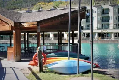 a group of boats parked under a pavilion next to the water at Keystone Slopeside Studio Condo in Keystone