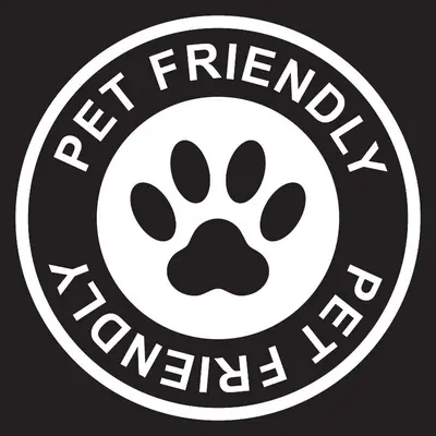 a white dog pawprint stamp with the text trained veterinary at 2002 Lupine Lane in Tabernash