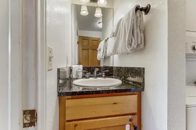 a bathroom with a sink and a mirror at On the Rapids in Grand Lake