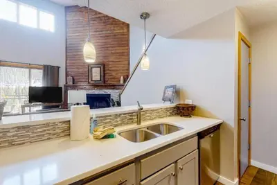 a kitchen with a sink and a counter top at 2 Bedroom Montezuma Condo At Lakeside Village - Shuttle To Slopes! in Keystone