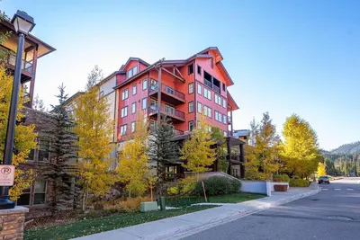 a large red building on the side of a street at Ski-In / Ski-Out 1 Bedroom Condo base of WP Resort in Winter Park