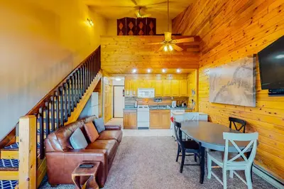 a living room with a couch and a table at Silver Lodge B in Granby