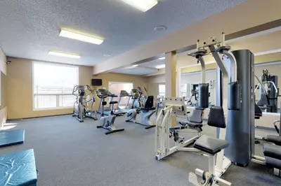 a gym with treadmills and machines in a room at Silver Lodge A in Granby