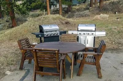 a table and chairs and a grill and a table with a table and a table at Fawn Valley Inn- 297 condo in Estes Park