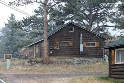 a wooden building with a sign in front of it at Triple R Cottages- 6 cabin in Estes Park