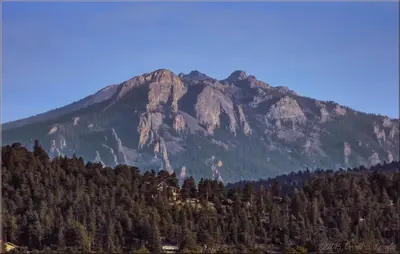 a large mountain with trees in front of it at Lazy R Cottages- 18 cabin in Estes Park