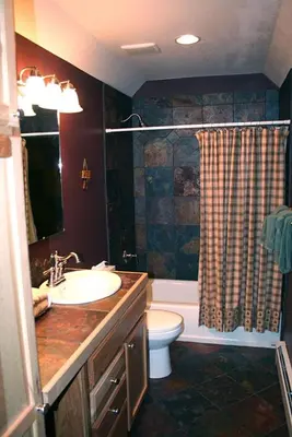 a bathroom with a sink and a toilet and a shower at Lazy R Cottages- 15 cabin in Estes Park