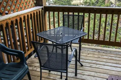 a patio table and chairs on a deck at Fawn Valley Inn- 303 apts in Estes Park