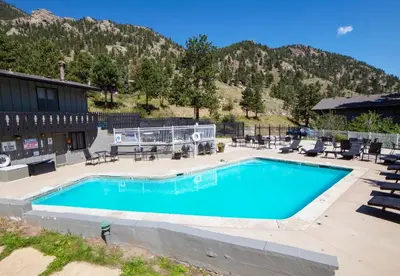 a swimming pool in front of a mountain at Fawn Valley Inn- 286 condo in Estes Park