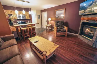 a living room with a couch and a fireplace at Fawn Valley Inn- 286 condo in Estes Park