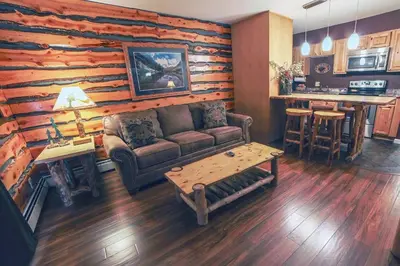 a living room with a couch and a table at Fawn Valley Inn- 286 condo in Estes Park