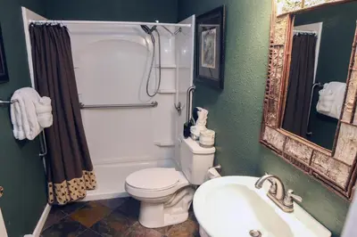 a bathroom with a toilet and a sink and a mirror at Fawn Valley Inn- 286 condo in Estes Park