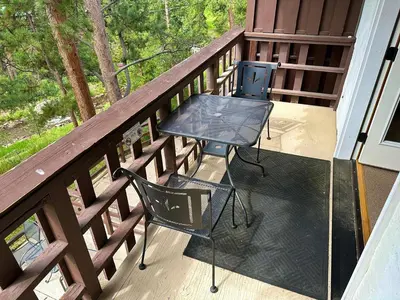 a table and two chairs on a balcony at Fawn Valley Inn- 286 condo in Estes Park