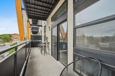 a balcony with a table and chairs and a window at Sleek & Chic Vibes | Espadin LoHi in Denver
