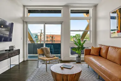 a living room with a couch and a table at Canvas & Comfort | Espadin LoHi in Denver