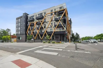 a large building on the corner of a street at Canvas & Comfort | Espadin LoHi in Denver