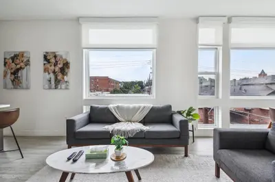 a living room with a couch and a table at Highline Hideaway | Espadin LoHi in Denver