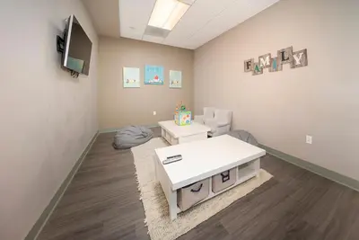 a waiting room with a white table and chairs at Hi Country Haus Unit 1803 in Winter Park