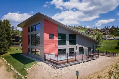 a home with a red and white house at Hi Country Haus Unit 1803 in Winter Park