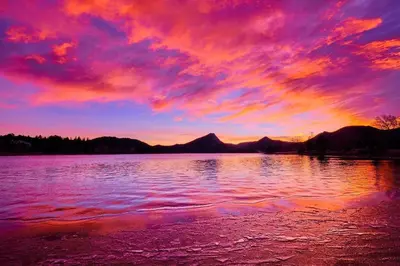 a sunset over a large body of water at Fall River Retreat - Monthly Long-Term Vacation Rental townhouse in Estes Park