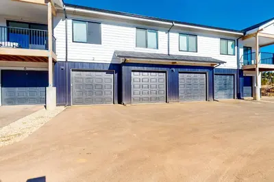 a large house with three garage doors in a driveway at Mellow on Meadow Mile 2B in Fraser