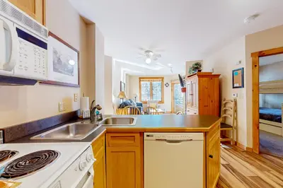 a kitchen with a sink and a stove at Mountainside Majesty in Keystone