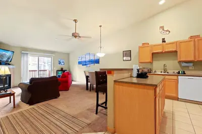 a large kitchen and living room with a couch and a table at 2BR Condo - Ideal Hub for Year-Round Fun in Silverthorne