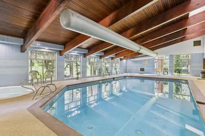 a large swimming pool in a house with a wooden ceiling at Colorado Condo about 2 Mi to Winter Park Resort! in Winter Park