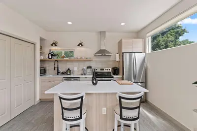 a kitchen with a white counter top and a refrigerator at Beautiful Denver Carriage House in Denver