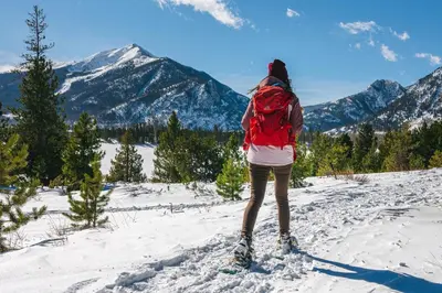 a person with a backpack standing on a snow covered mountain at Frisco Mountainside Retreat: Walk Downtown in Frisco