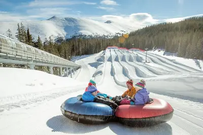 two children are riding on a tube in the snow at 3Br Ski-in Ski-out-On Mountain-Lone Eagle 3053 condo in Dillon