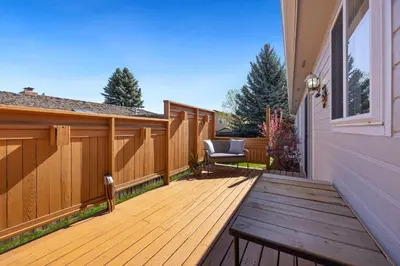 a wooden deck with a chair on a house at Colorado Mountain Retreat - Easy access to RMNP! in Loveland