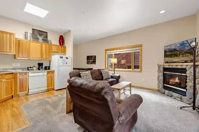 a living room with a couch and a fireplace at Bugle Pointe A13 by Estes Park Condos in Estes Park