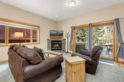 a living room with leather furniture and a fireplace at Bugle Pointe A13 by Estes Park Condos in Estes Park
