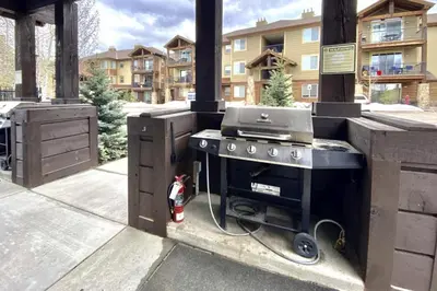 a outdoor kitchen with a grill on a patio at Trailhead Lodge 621 condo in Winter Park