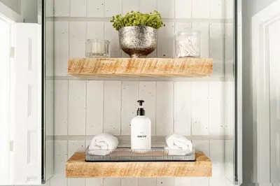 a bathroom with a shelf with a bottle of soap at Chic Condo - Near Town and Trails - Hot Tub - Deck in Fraser