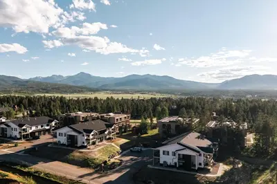 an aerial view of a home with mountains in the background at Chic Condo - Near Town and Trails - Hot Tub - Deck in Fraser
