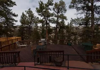 a deck with a table and a bench on a deck at Diamond - The Historic Crags Lodge - 2BD in Estes Park