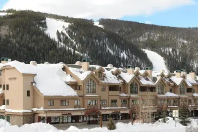 a large building with snow on top of it at 2 Bedroom Gateway Lodge Condo Near Mountain House in Keystone