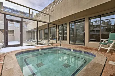 a swimming pool in the middle of a house at Ski Retreat with Hot Tub Access in Winter Park! in Winter Park