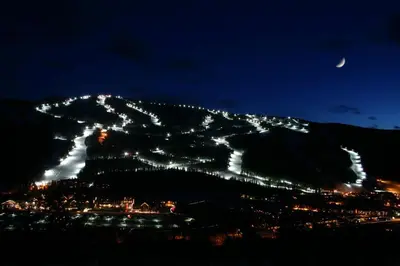 a night view of a mountain with lights on it at Slopeside 2730A by SummitCove Lodging in Keystone