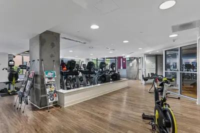 a gym with treadmills and bikes in a room at 1700 Bassett, Unit 711 in Denver