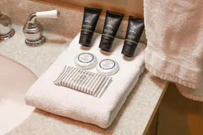 a bathroom counter with a white towel on a sink at La Riva Del Lago Condo: Downtown, Close to Everything in Dillon