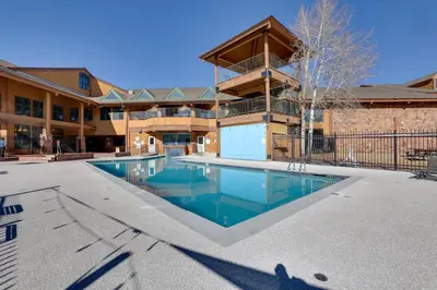 a swimming pool in the courtyard of a building at 2 Mi to Granby Ranch Mtn-View Studio with Perks in Granby